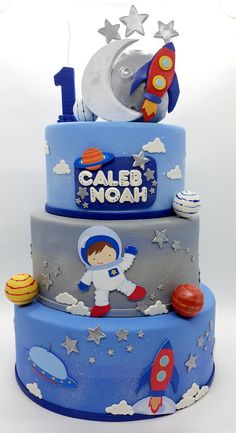 a three tiered cake with an outer space theme