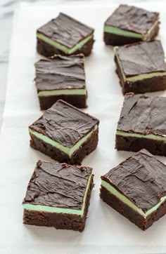 several pieces of chocolate cake with green frosting