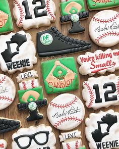 decorated cookies are displayed on a table for someone's baseball themed birthday cake topper