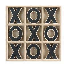 a wooden box with letters that spell out the word xoxo in black and white