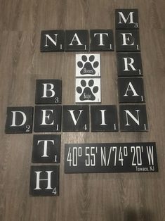 some black and white tiles are arranged on a wooden floor with the words national dog day written in them