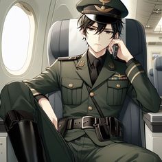 a man in uniform sitting on an airplane talking on a cell phone while holding his hand to his ear