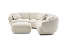 a white couch and ottoman with pillows on it