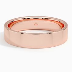 a rose gold wedding ring on a white background