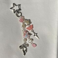 a close up of a charm on a white surface with stars and other items around it