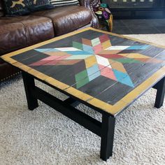 a coffee table made out of wooden boards and painted with multicolored stars on it