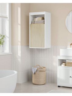 a bathroom with a sink, mirror and white cabinet in the corner next to a bathtub