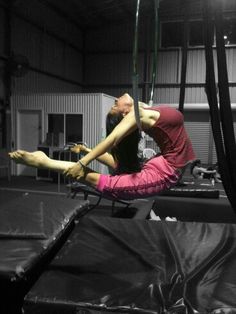 a man is doing aerial acrobatics on a trampoline