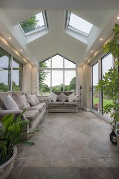 a living room filled with furniture and lots of windows