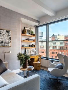 a living room filled with furniture and a large window