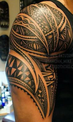 a man's arm with an intricate tattoo design on the back of his arm