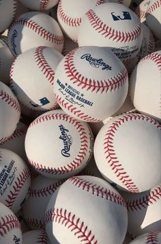 a pile of baseballs sitting next to each other