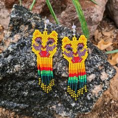 the beaded earrings are designed to look like a lion with colorful beads on it