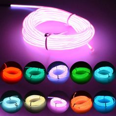 various colors of neon lights on a purple background with white wire and black cord in the middle