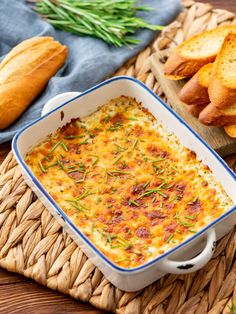 a casserole dish with bread on the side