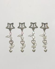 four pairs of dangling earrings with hearts and stars