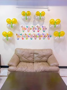 a living room filled with furniture and balloons in the shape of butterfly's on the wall