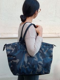 Handmade Camo Leather Tote Bag. Versatile and Stylish Handbag for Every Occasion. Introducing our Boston Bag. A luxurious and spacious leather tote that seamlessly combines functionality with high fashion. This tote is expertly handcrafted in our Barcelona atelier from premium calf leather, featuring a striking grey, blue, and black camouflage design that adds a unique touch to any outfit. Perfect for Every Day and Beyond. This camo leather tote is designed to complement any style, making it the perfect choice for work, shopping, travel, or a day out. Its unique blend of practicality and fashion ensures it will become a staple in your wardrobe. FEATURES: Premium Materials: Made with high-quality calf leather in a distinctive camouflage pattern, this tote is both durable and stylish. Versat Soft Leather Tote, Large Leather Bag, Camouflage Design, Carryall Tote, Daily Bag, Sac Week End, Blue Camouflage, Travel Bags For Women, Large Leather Tote