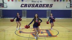 the cheerleaders are dancing on the basketball court