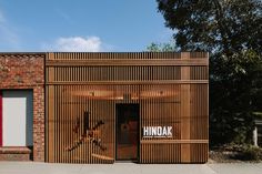 the entrance to a building with wooden slats on it