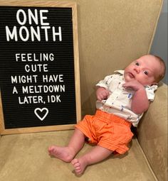 a baby sitting on a chair next to a sign that says one month feeling cute might have a meltdown later, idk