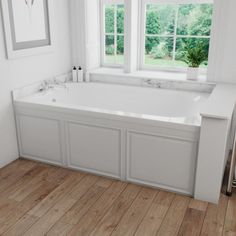 a large white bath tub sitting next to two windows