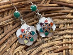 This beautiful flower of life earring is handmade by the beautiful Quechua people of the Peruvian Andes. This flower of life design contains a spiral within which in Andean cosmology represents Pachamama / Mother Earth... The one who is always giving unconditionally It is made by silver and various gemstones like lapiz azul, crystacola (peruvian turquiose) , mother of pearl, spondyllus Weight : 7.2 gr Width : 1.5 cm Height ( with hook) : 4.3 cm It is handmade in 950 silver with inlaid stone and Artisan Flower Earrings, Traditional Flower Earrings For Gift, Traditional Flower Shaped Earrings For Gifts, Traditional Flower-shaped Jewelry With Ear Wire, Traditional Nickel-free Jewelry With Flower Shape, Traditional Nickel-free Flower-shaped Jewelry, Blossoming Flower, Flower Of Life, Blossom Flower