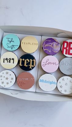 an open box filled with lots of different colored cupcakes