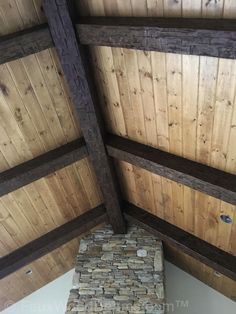 the inside of a building with wooden walls and beams