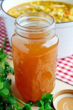 a jar filled with soup sitting on top of a table