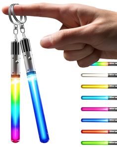 a hand holding a lighter keychain with four different colored lights on each side