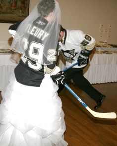 a bride and groom are dressed up in ice hockey gear for their wedding reception at the lodge