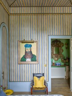 a room with striped walls and a painting on the wall