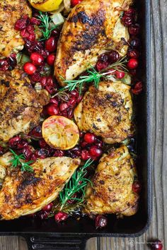 chicken with cranberries and onions in a roasting pan