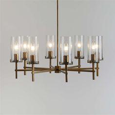 a chandelier with six lights hanging from it's center and four rows of glass tubes on each end