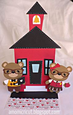 two bears are standing in front of a paper house