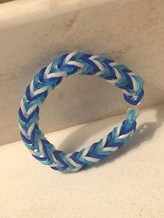 a blue and white bracelet sitting on top of a counter