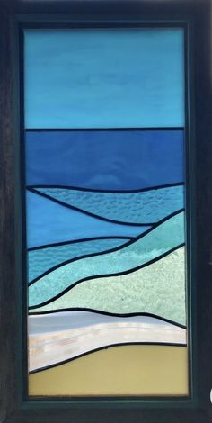 a stained glass window with an ocean scene