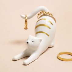 Stretching Cat Ring Holder with gold accents and rings on its tail. Stretching Pose, Quirky Homeware, Stretching Cat, Cat Tea Towel, Cat Ring Holder, Dog Ring, Precious Rings, Ceramic Cat, Cats For Sale