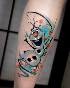 a cartoon character tattoo on the leg of a person with an orange and blue background