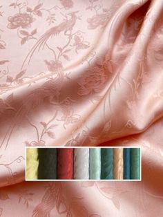 an image of a pink satin fabric with flowers and birds on it, all in different colors