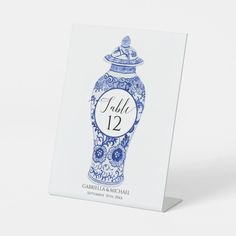 a blue and white vase with the number twelve on it's front is shown