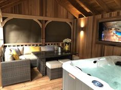 a hot tub sitting inside of a living room next to a tv