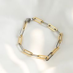 This bold two-tone link chain bracelet features 4 mm paperclip chain links in gold and silver secured with a lobster claw clasp in silver. Crafted in stainless steel, this bracelet is waterproof and tarnish-resistant. Add personalization with a letter charm. Pair it with our matching necklace: https://www.etsy.com/ca/listing/1455733560/18k-gold-paperclip-necklace-waterproof Bracelet Size Guide: The length measurement of our bracelets includes the clasp. To measure your bracelet size, wrap a flex Silver Link Bracelets With Gold Chain, Silver Link Bracelet With Gold Chain, Metal Paperclip Bracelet With Box Chain, Silver Tarnish-resistant Paperclip Chain Bracelet, Silver Link Paperclip Bracelet, Tarnish Resistant, Silver Bracelets With Rectangular Links And Gold Chain, Silver Tarnish-resistant Link Paperclip Bracelet, Stainless Steel Paperclip Chain Bracelet As Gift, Silver Paperclip Bracelet With Gold Chain Link