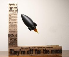 a wooden block with an image of a rocket on it and the words, they're off for the moon