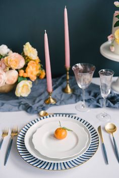 the table is set with plates and silverware