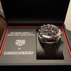 Tag Heuer Formula 1 Mario Kart Watch. Brand New Watch, Still Under Warranty With It's Original Box And Accessories. Watch Is 44mm With Leather Strap. Strap Has A 'Tortoise Shell" Pattern With Red Accent Stitching And Metal Clasp With Mario's M Inscribed. Many Unique Mario Details Throughout The Watch. Perfect For Any Mario Kart Lover. All Original, Bought Directly From Tag Heuer. Luxury Chronograph Watch As Gift, Black Watches For Anniversary With Round Dial, Designer Automatic Watches As Gift, Designer Black Watch For Anniversary, Black Anniversary Watch With Round Dial, Black Anniversary Watch, Black Anniversary Watches, Luxury Red Chronograph Watch, Leather Chronograph Watch With Analog Display As Gift