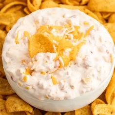 a white bowl filled with chips and dip