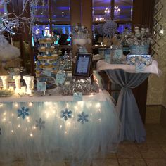 a table topped with lots of desserts covered in snowflakes