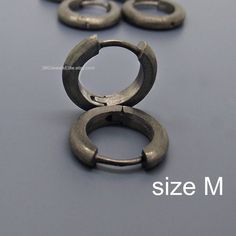 Men's medium sized huggie hoop earrings in 9mm. These hoop earrings have a slight dome design and flat edges. Sold as a pair or single earring. SPECIFICATION Base metal: Recyclable fine 925 Sterling Silver Outer layer : Black plating, matte finish Outer Diameter: 13mm Inner Diameter: 9mm, size M Width: 2.5mm Ear Post Gauge: 20G Measurements are an approximation. Available in polished white https://www.etsy.com/listing/250896161 Thank you for your interest in our domed hoop earrings for men. Adjustable Small Hoop Earrings, Hypoallergenic Metal Hoop Earrings, Small Metal Hoop Earrings, Mens Hoop Earrings, Hooped Earrings, Earrings Mens, Men's Earrings, Tragus Hoop, Mens Earrings Hoop